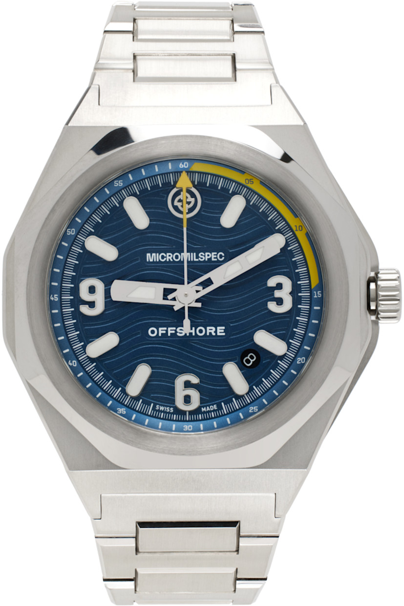 Lugged round case in polished and brushed stainless steel. Fixed bezel. Anti-glare and scratch-resistant domed sapphire crystal lens. Super-Luminova glow-in-the-dark logo and markers in white, yellow, and silver-tone. Graphic, embossed stripes, and date aperture at brushed blue dial. Logo engraved at fluted screw-down crown.

H-link strap in polished stainless steel with logo-etched butterfly-buckle fastening.

26-jewel Sellita 200-1 automatic movement. 200m water resistance. Swiss-made. Logo engraved at case back.

Approx. 42 mm case length x 12 mm case height; 0.75” strap width.

This item is part of a limited run of 200.

Supplier color: Steel