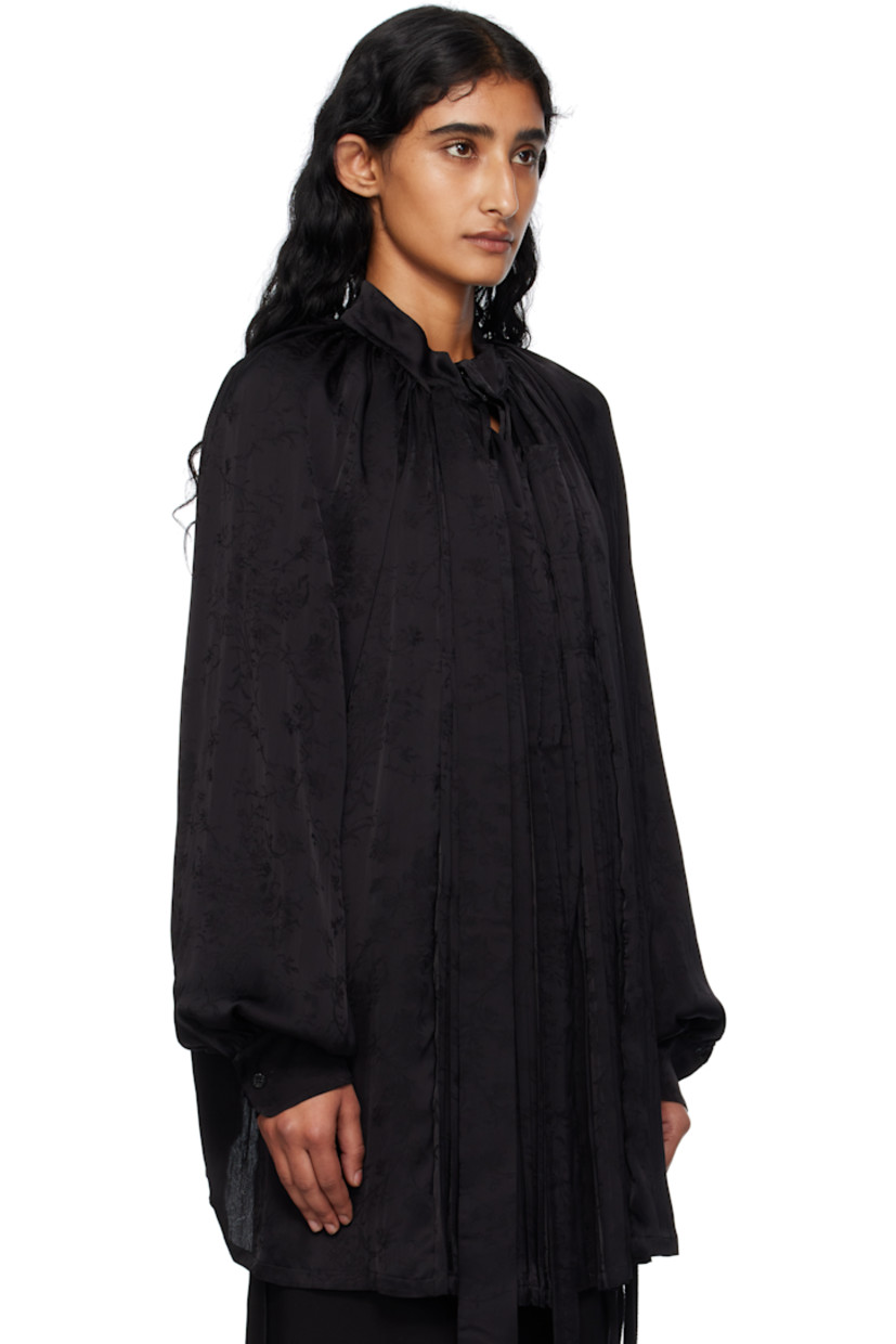 Viscose- and silk-blend brocade shirt. 

· Knife pleats and jacquard floral pattern throughout
· Detachable extended trim at band collar
· Button closure
· Gathering at shoulders
· Raglan sleeves
· Buttoned barrel cuffs

Supplier color: Black