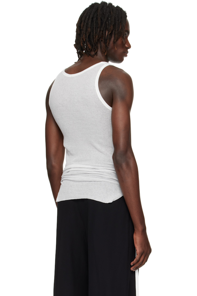 Lightweight rib-knit cotton tank top.

· Semi-sheer
· Scoop neck
· Raw edge at hem
· Ruching with grosgrain strap at sides

Supplier color: Natural White