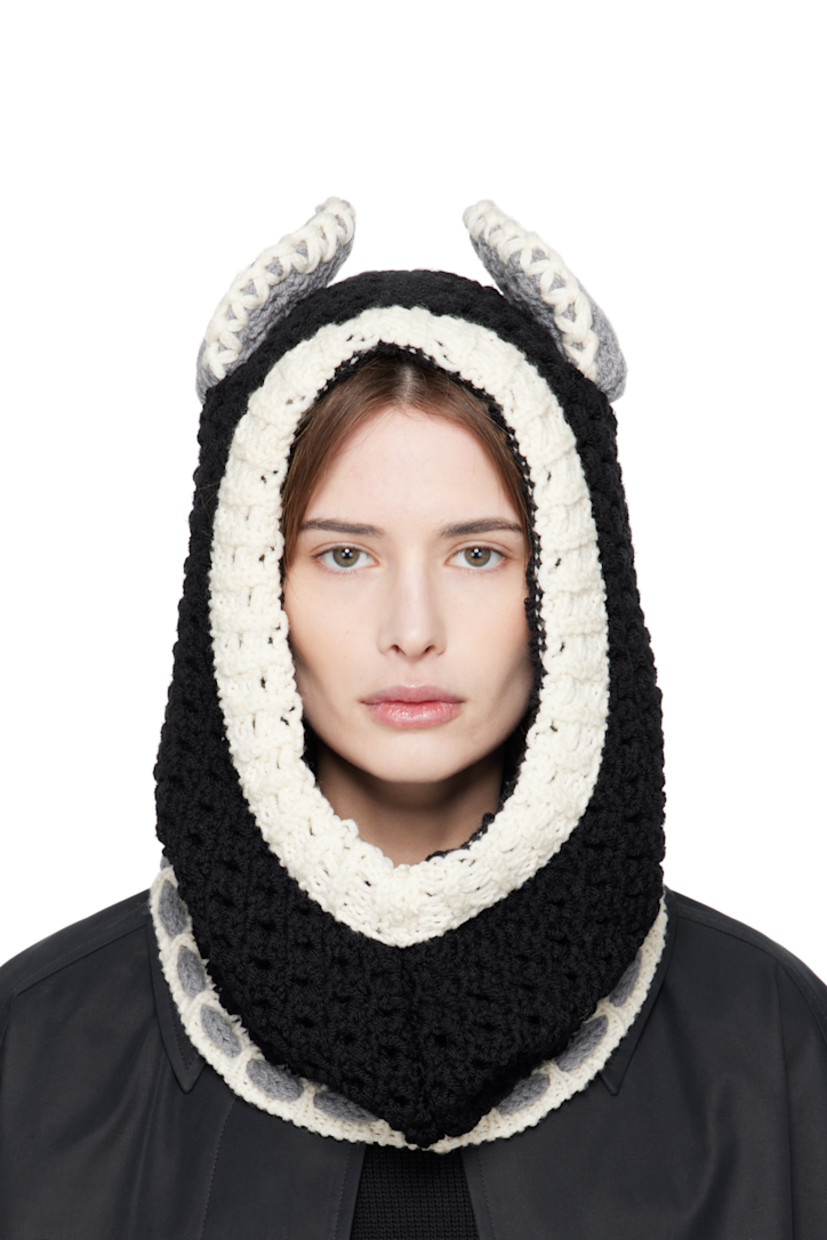 Open-knit virgin wool balaclava in black and off-white.

· Ear appliqués at crown
· Self-tie fastening
· Unlined

Supplier color: Black