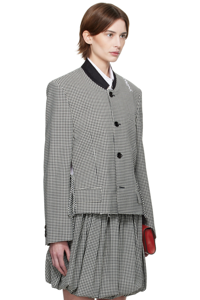 Plain-woven stretch polyester- and virgin wool-blend jacket. Gingham pattern throughout. 

· Felted band collar 
· Button closure
· Welt pocket at chest
· Mock flap pockets
· Self-tie straps at vented side seams 
· Raw edge at hem 
· Padded shoulders
· Hand-embroidered logo at shoulder
· Three-button surgeon's cuffs
· Welt pocket at interior 
· Full satin lining 
· Logo-engraved black hardware

Supplier color: Black