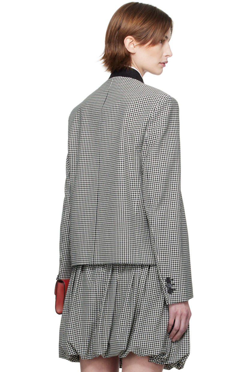 Plain-woven stretch polyester- and virgin wool-blend jacket. Gingham pattern throughout. 

· Felted band collar 
· Button closure
· Welt pocket at chest
· Mock flap pockets
· Self-tie straps at vented side seams 
· Raw edge at hem 
· Padded shoulders
· Hand-embroidered logo at shoulder
· Three-button surgeon's cuffs
· Welt pocket at interior 
· Full satin lining 
· Logo-engraved black hardware

Supplier color: Black