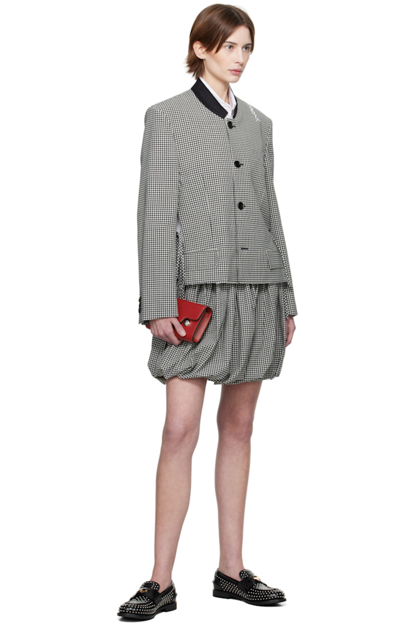 Plain-woven stretch polyester- and virgin wool-blend jacket. Gingham pattern throughout. 

· Felted band collar 
· Button closure
· Welt pocket at chest
· Mock flap pockets
· Self-tie straps at vented side seams 
· Raw edge at hem 
· Padded shoulders
· Hand-embroidered logo at shoulder
· Three-button surgeon's cuffs
· Welt pocket at interior 
· Full satin lining 
· Logo-engraved black hardware

Supplier color: Black