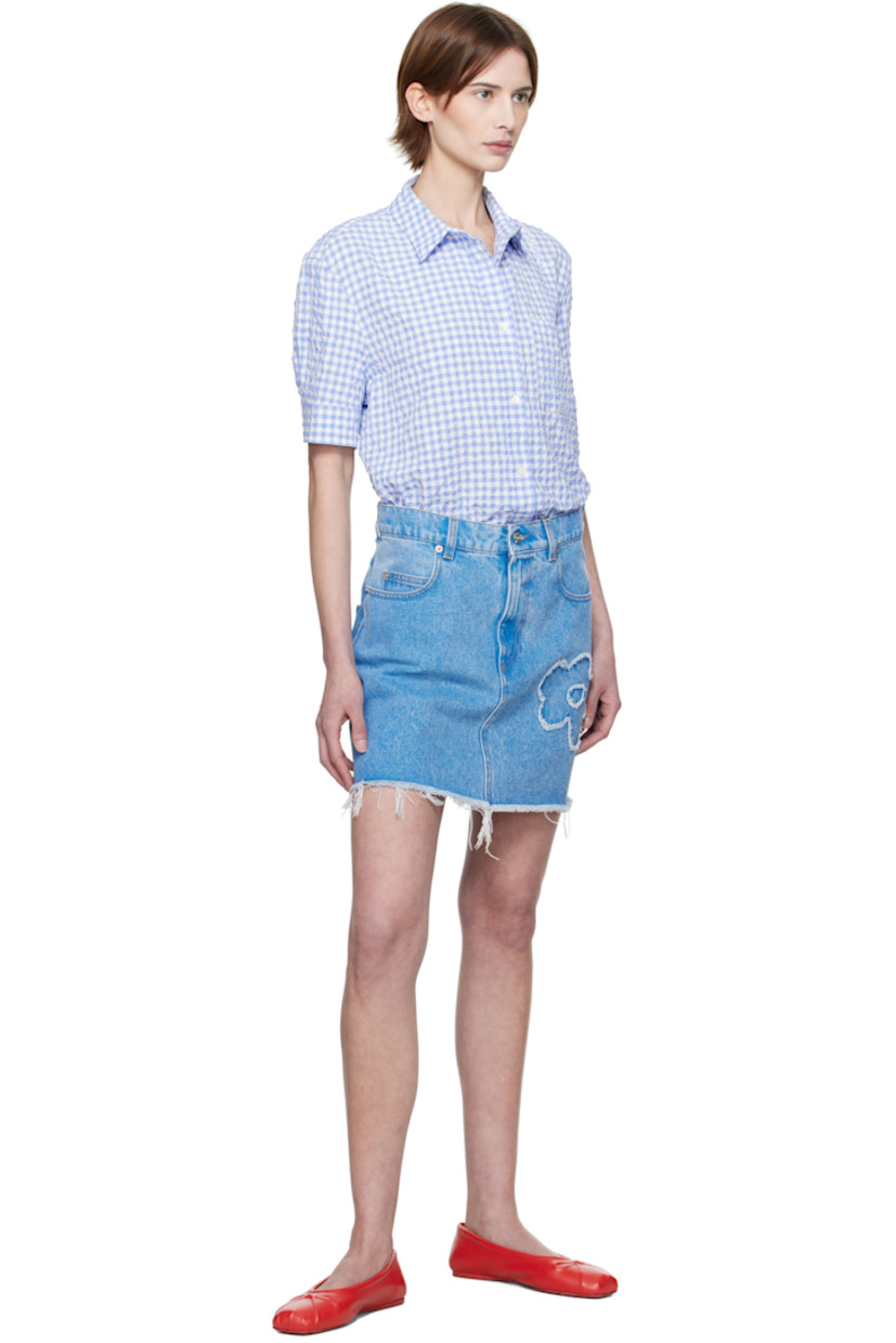 Non-stretch denim miniskirt. Fading throughout.

· Belt loops
· Five-pocket styling
· Zip fly
· Floral appliqué at front and back
· Frayed edge at flared hem
· Logo patch at back waistband
· Logo-engraved silver-tone hardware
· Contrast stitching in tan

Supplier color: Cobalt