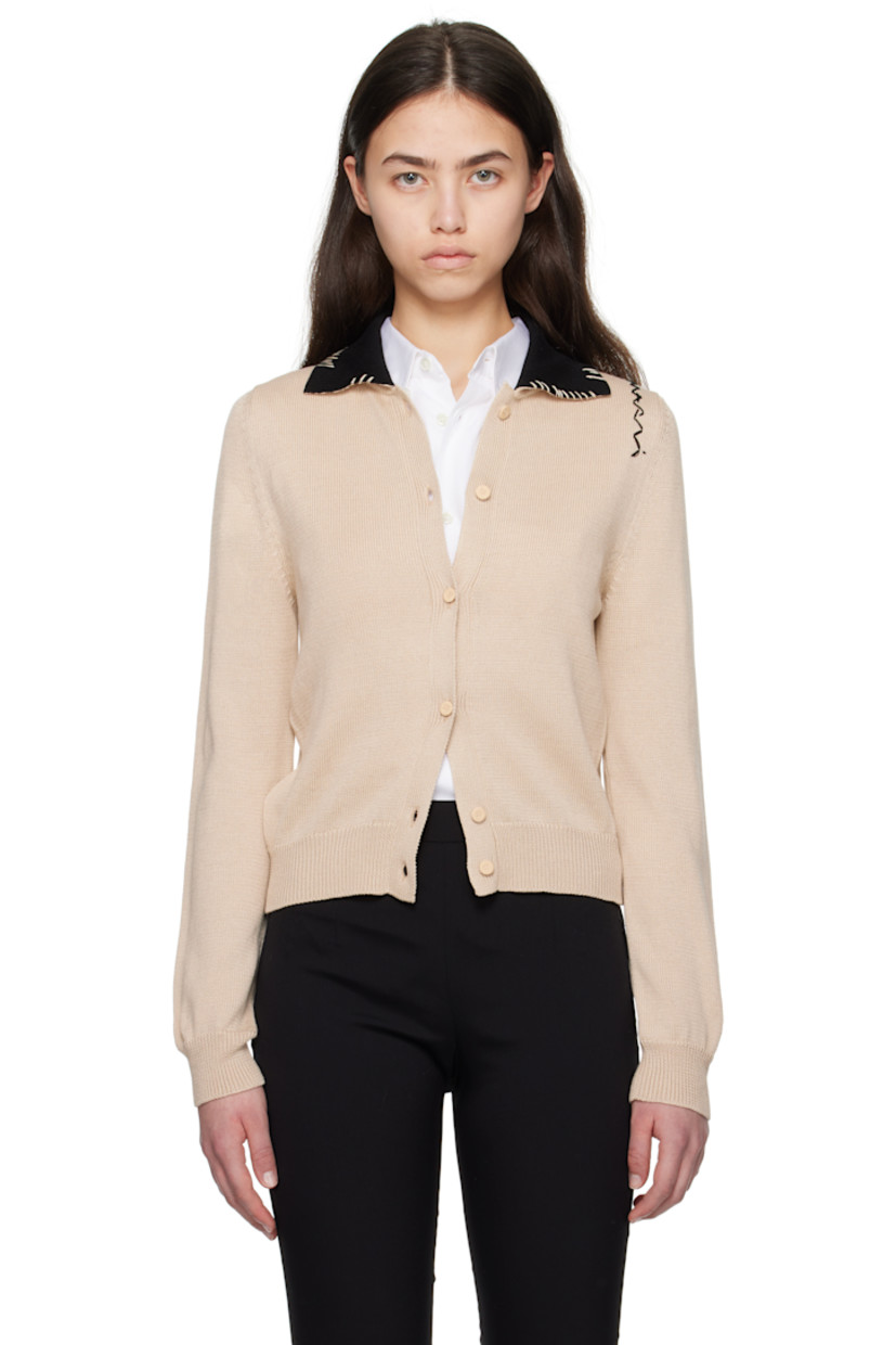 Knit cotton cardigan. 

· Blanket stitching at rib-knit spread collar
· Button closure 
· Rib-knit hem and cuffs
· Hand-stitched logo at shoulder

Supplier color: Pale peach