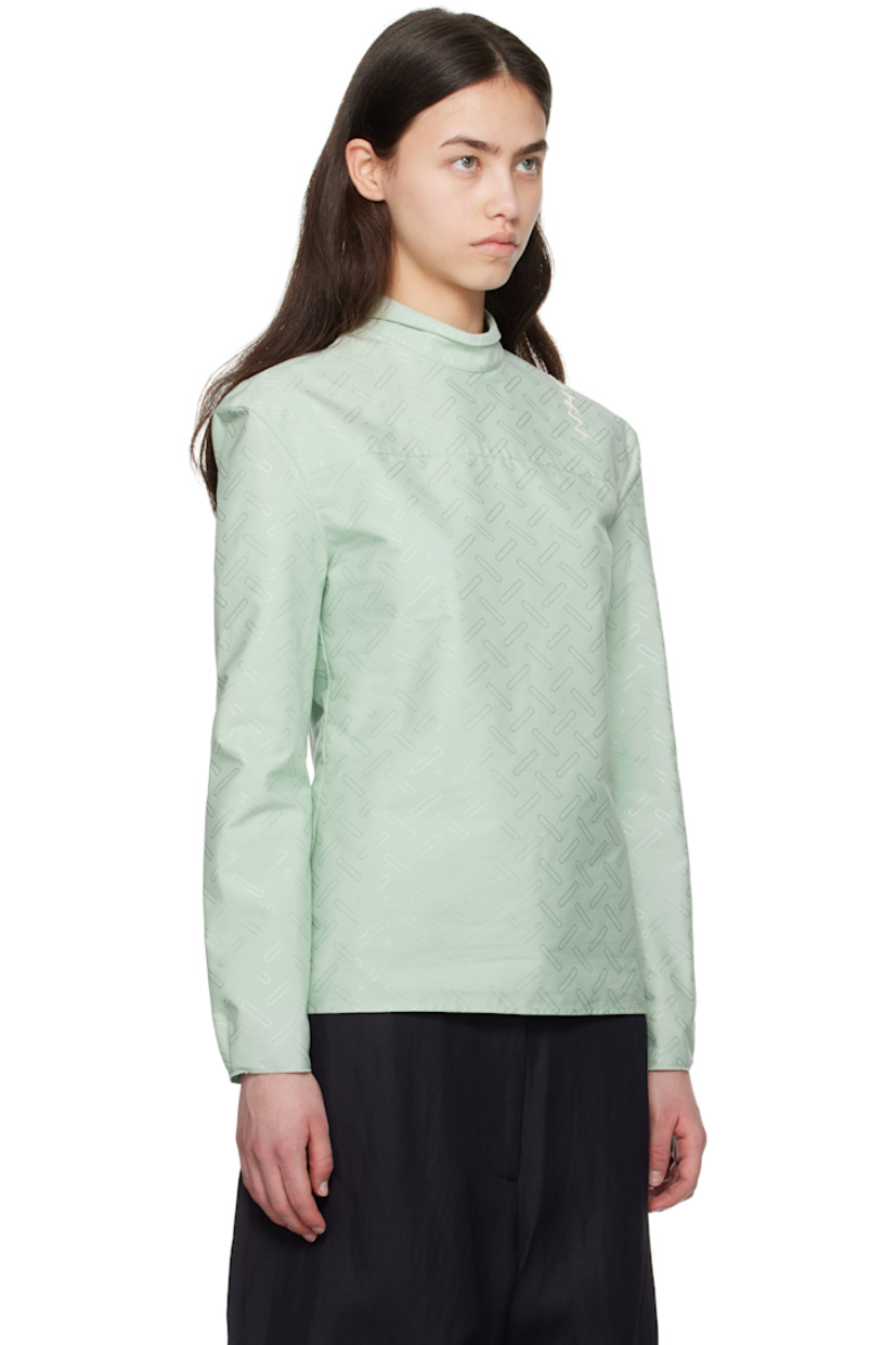 Plain-woven cotton-blend shirt. Jacquard graphic pattern throughout. 
 
· Can be worn front to back
· Spread collar
· Button closure
· Darts at front
· Pleats and raw edge at buttoned barrel cuffs
· Logo embroidered at back shoulder

Supplier color: Linden