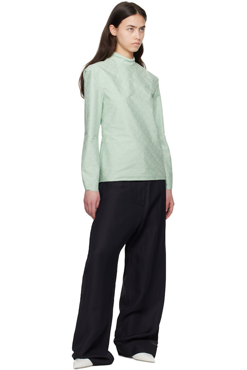 Plain-woven cotton-blend shirt. Jacquard graphic pattern throughout. 
 
· Can be worn front to back
· Spread collar
· Button closure
· Darts at front
· Pleats and raw edge at buttoned barrel cuffs
· Logo embroidered at back shoulder

Supplier color: Linden