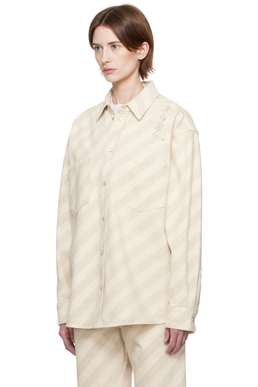 Non-stretch denim shirt. Stripes throughout. 

· Spread collar
· Press-stud closure
· Patch pockets
· Shirttail hem
· Logo appliqué at shoulder 
· Dropped shoulders
· Pleat and press-stud fastening at cuffs
· Twin pleats at yoke 

Supplier color: Bone