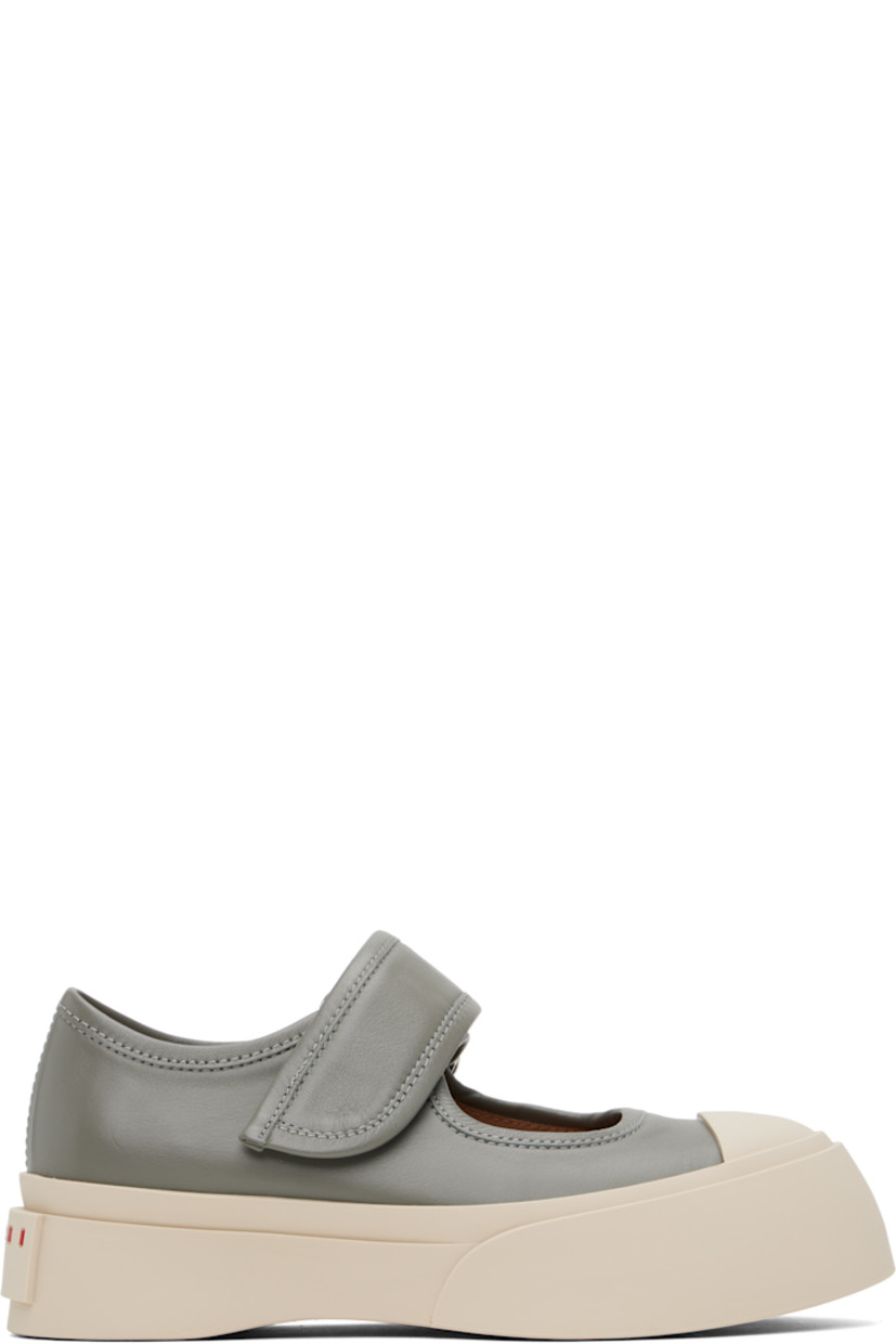 Low-top buffed nappa calfskin Mary Jane-style sneakers in gray.

· Rubber cap toe
· Velcro strap at vamp
· Metal eyelets at inner side
· Buffed sheepskin lining
· Logo embossed at heel
· Treaded rubber platform sole
· Platform: H1.75"

Supplier color: Neutral grey