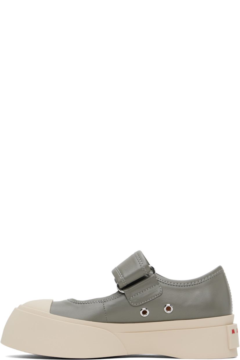 Low-top buffed nappa calfskin Mary Jane-style sneakers in gray.

· Rubber cap toe
· Velcro strap at vamp
· Metal eyelets at inner side
· Buffed sheepskin lining
· Logo embossed at heel
· Treaded rubber platform sole
· Platform: H1.75"

Supplier color: Neutral grey