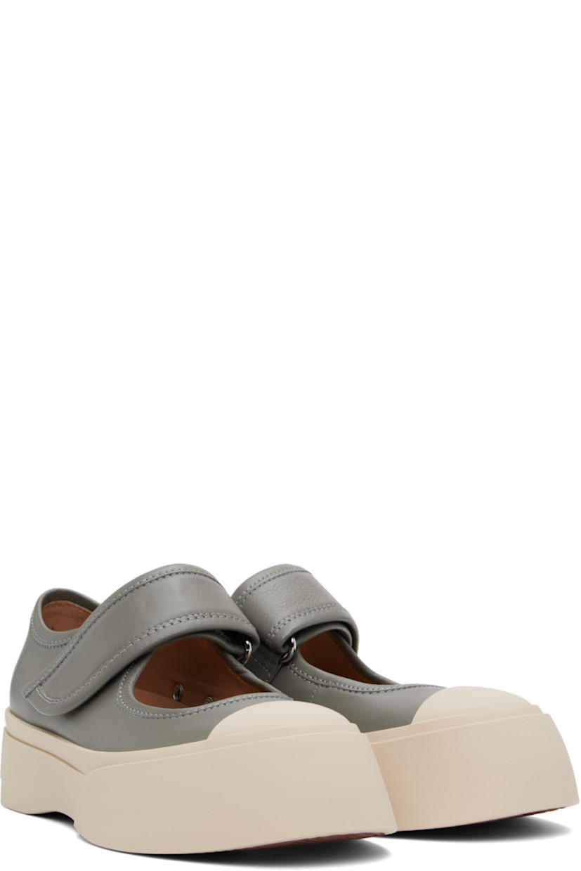 Low-top buffed nappa calfskin Mary Jane-style sneakers in gray.

· Rubber cap toe
· Velcro strap at vamp
· Metal eyelets at inner side
· Buffed sheepskin lining
· Logo embossed at heel
· Treaded rubber platform sole
· Platform: H1.75"

Supplier color: Neutral grey