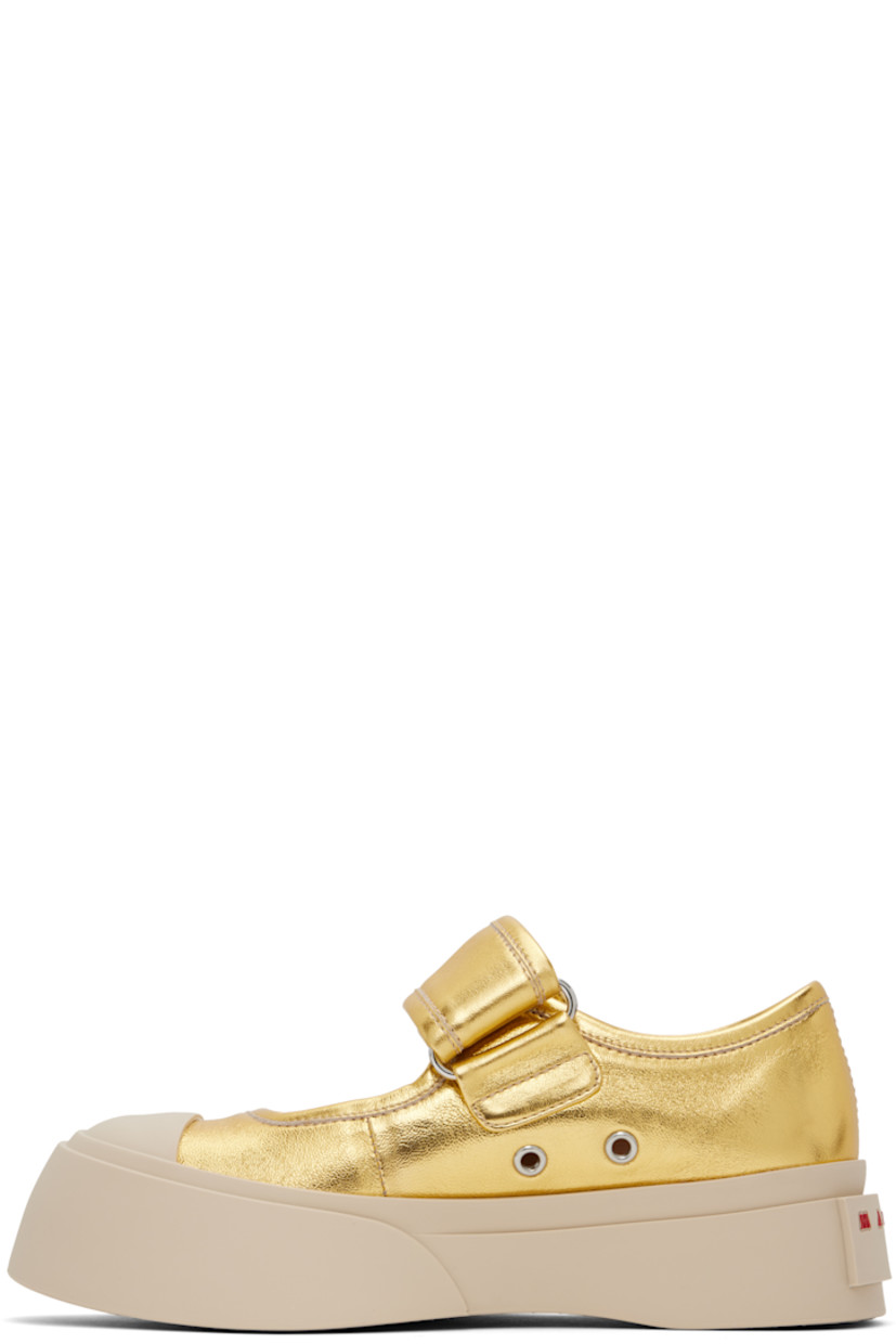 Grained leather Mary Jane-style ballerina flats in gold tone.

· Rubber cap toe
· Velcro strap at vamp
· Metal eyelets at inner side
· Buffed calfskin lining
· Logo embossed at heel
· Treaded rubber platform sole
· Platform: H1.75"

Supplier color: Gold