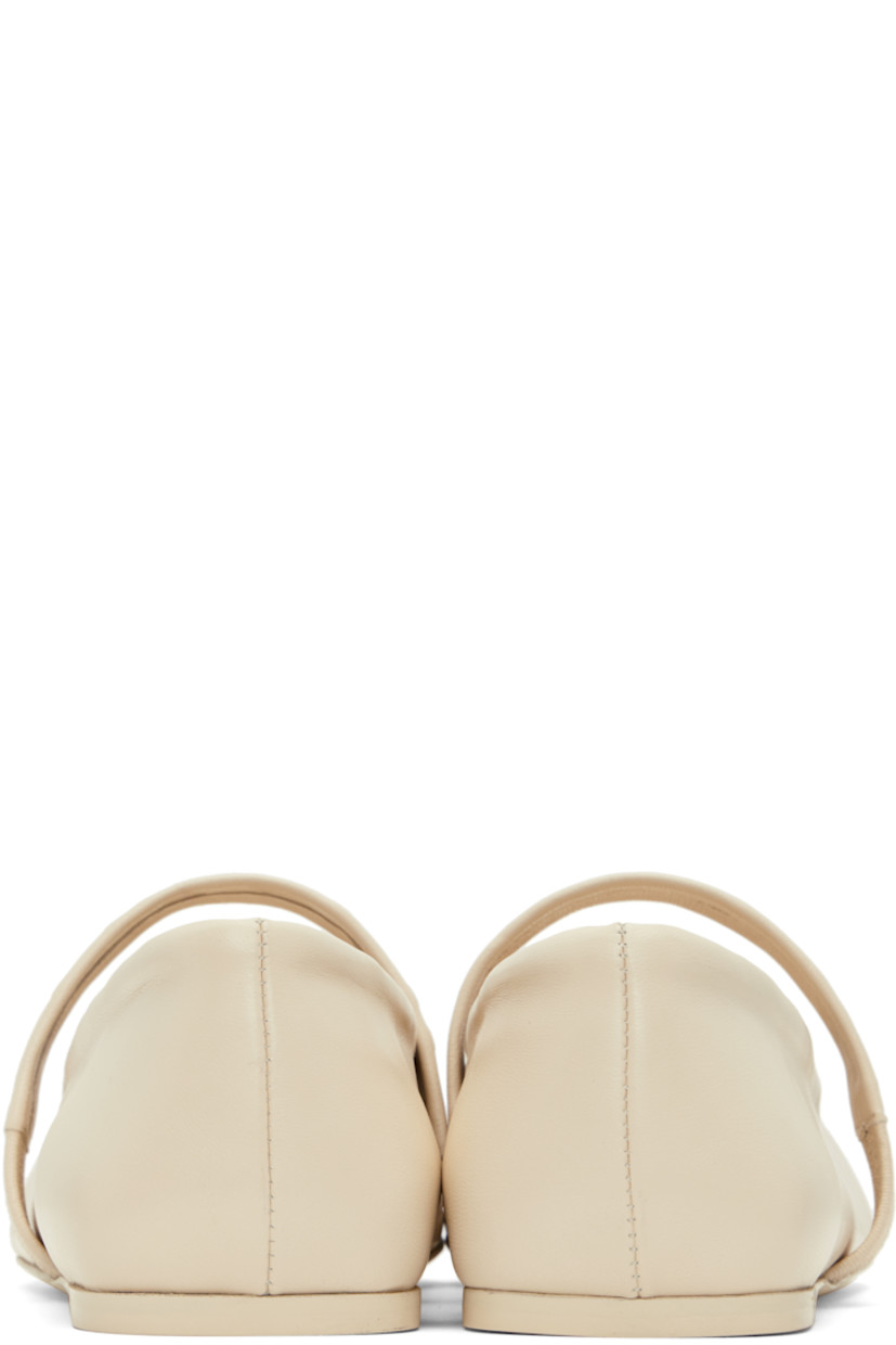 Buffed leather Mary Jane-style ballerina flats in off-white.

· Embossed bow graphic at square toe
· Logo-embossed elasticized strap at vamp
· Suede and buffed leather lining
· Leather sole with rubber injection

Supplier color: Limestone