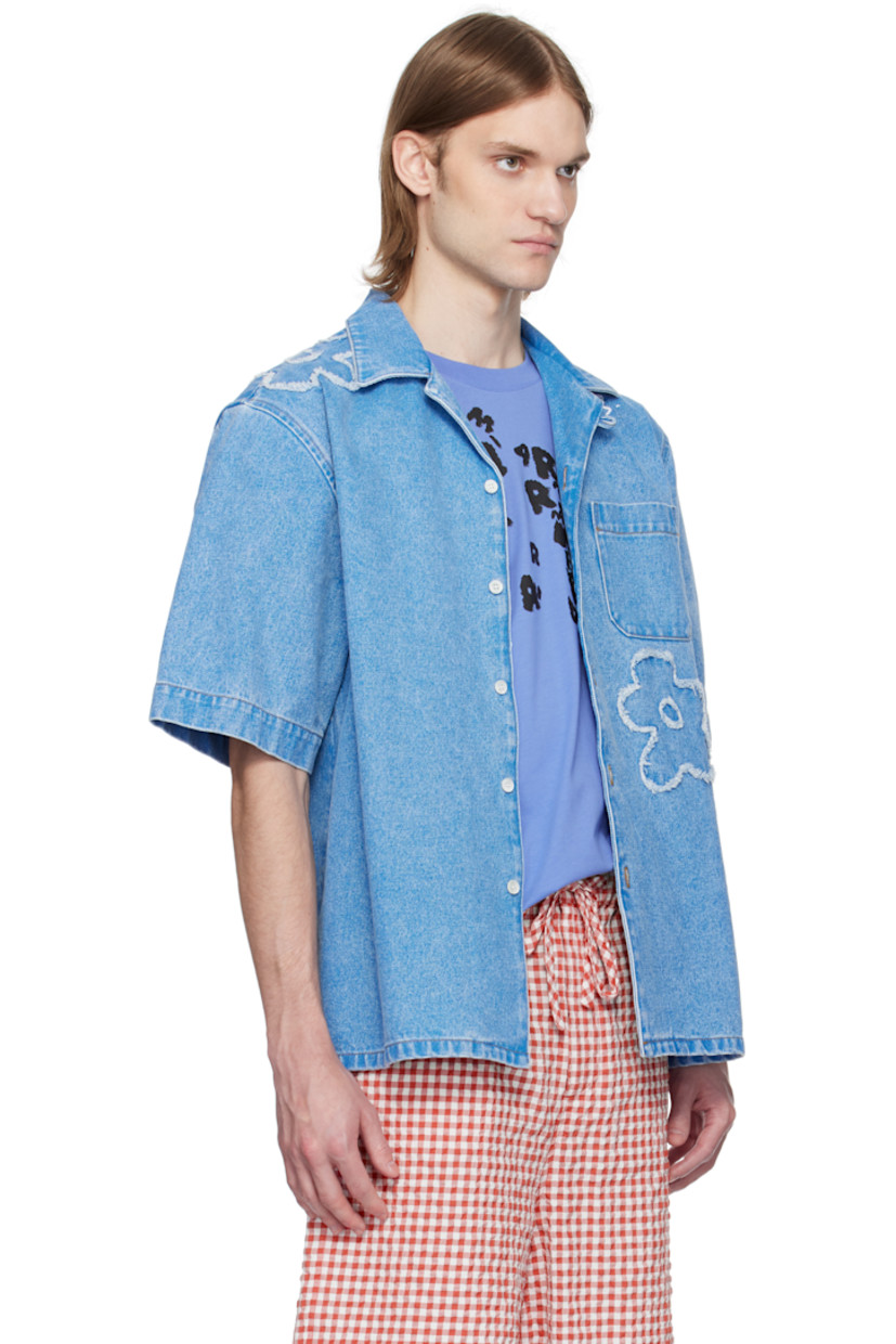 Non-stretch denim shirt. Fading throughout.

· Open spread collar
· Button closure
· Patch pocket at chest
· Frayed floral appliqué at front and shoulder
· Vent at side seams
· Hand-stitched logo at shoulder
· Mother-of-pearl hardware
· Contrast stitching in tan

Supplier color: Cobalt