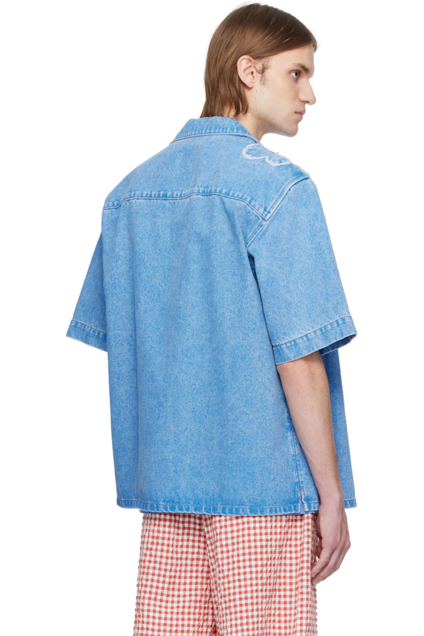 Non-stretch denim shirt. Fading throughout.

· Open spread collar
· Button closure
· Patch pocket at chest
· Frayed floral appliqué at front and shoulder
· Vent at side seams
· Hand-stitched logo at shoulder
· Mother-of-pearl hardware
· Contrast stitching in tan

Supplier color: Cobalt
