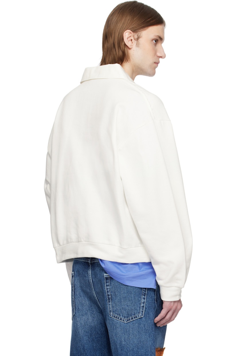 French terry polo.

· Spread collar
· Three-button placket
· Rib-knit hem and cuffs
· Frayed edge at shoulder seams
· Hand-stitched logo at shoulder
· Dropped shoulders
· Logo-engraved hardware

Supplier color: Natural white