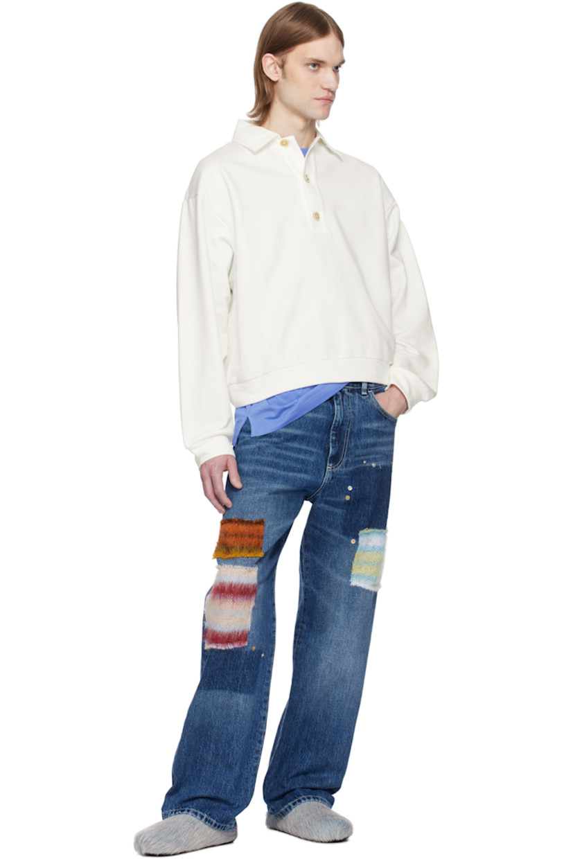 French terry polo.

· Spread collar
· Three-button placket
· Rib-knit hem and cuffs
· Frayed edge at shoulder seams
· Hand-stitched logo at shoulder
· Dropped shoulders
· Logo-engraved hardware

Supplier color: Natural white