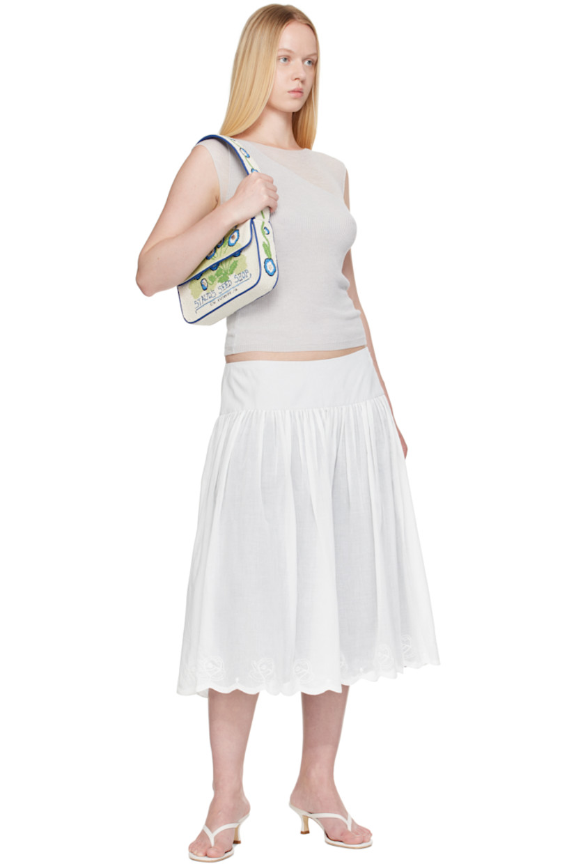 Hand-beaded shoulder bag.

· Beaded floral graphics and faux-leather trim throughout
· Fixed shoulder strap
· Text embroidered at face and back face
· Patch pocket and beaded logo at back face
· Magnetic press-stud flap
· Zip pocket at interior
· Satin lining
· H6.25" x W10" x D2"

Supplier color: Baby blue eyes