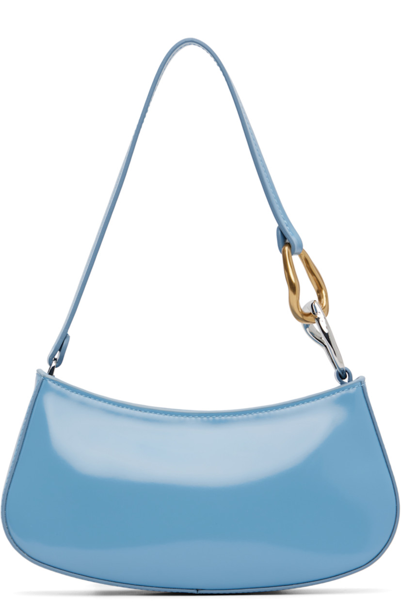 Polished leather shoulder bag.

· Curb chain hardware at fixed shoulder strap
· Logo embossed at back face
· Zip closure
· Zip pocket and patch pocket at interior
· Suede lining
· Silver-tone and gold-tone hardware
· H4.25" x W9.5" x D2"

Supplier color: Staud blue
