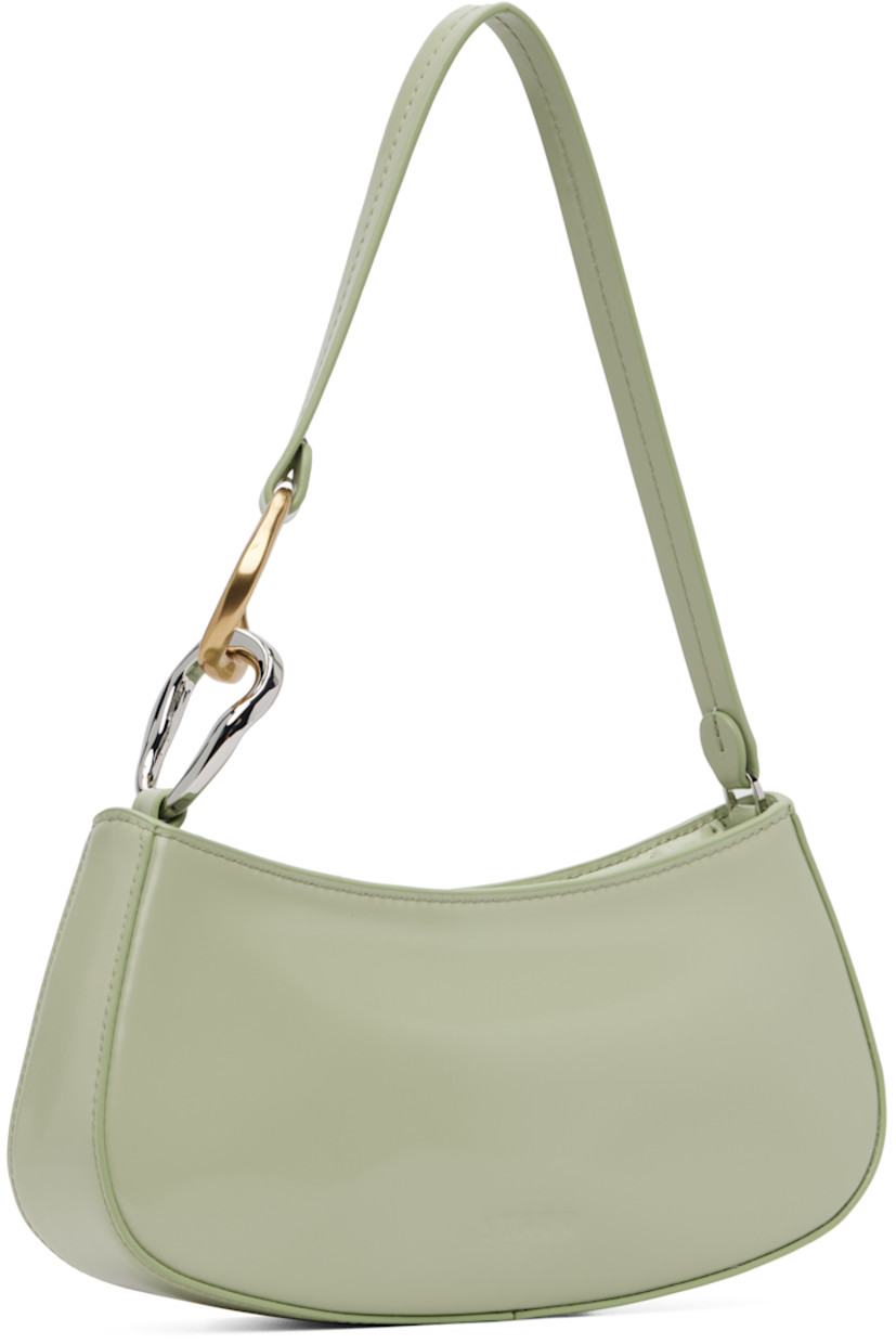 Polished leather shoulder bag.

· Curb chain hardware at fixed shoulder strap
· Logo embossed at back face
· Zip closure
· Zip pocket and patch pocket at interior
· Suede lining
· Silver-tone and gold-tone hardware
· H4.25" x W9.5" x D2"

Supplier color: Pale jade
