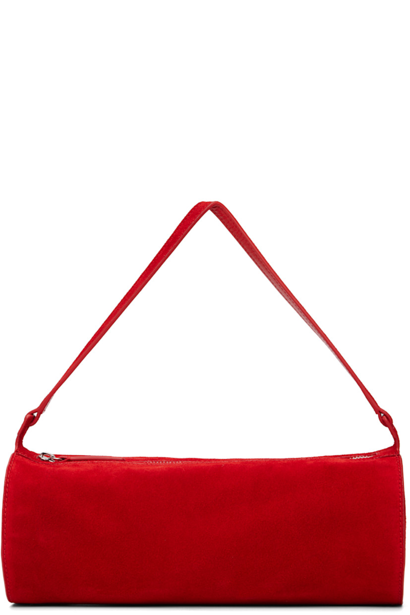 Suede shoulder bag.

· Fixed shoulder strap
· Logo embossed at side
· Zip closure
· Zip pocket at interior
· Faille lining
· H4.5" x W11.25" x D4.5"

Supplier color: Red rose