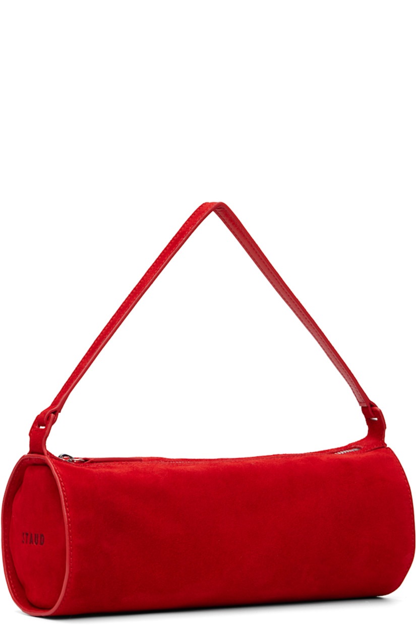 Suede shoulder bag.

· Fixed shoulder strap
· Logo embossed at side
· Zip closure
· Zip pocket at interior
· Faille lining
· H4.5" x W11.25" x D4.5"

Supplier color: Red rose