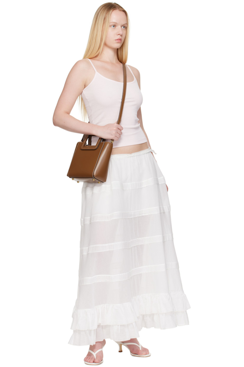 Buffed leather top handle bag.

· Fixed carry handles
· Adjustable and detachable crossbody strap
· Bumper studs and embossed logo at base
· Removable zip pouch at interior
· Suede lining
· Contrast stitching in white
· H8" x W8.25" x D4.5"

Supplier color: Saddle