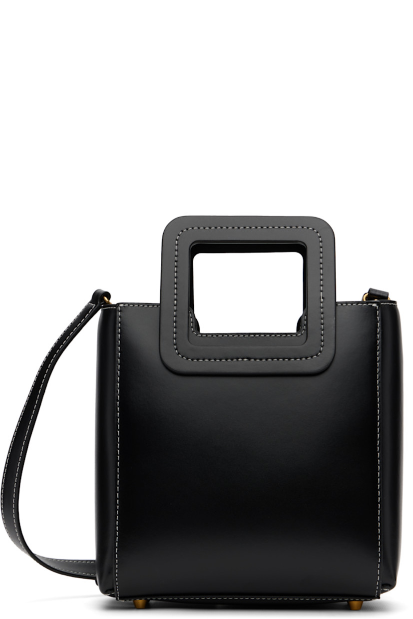 Buffed leather top handle bag.

· Fixed carry handles
· Adjustable and detachable crossbody strap
· Bumper studs and embossed logo at base
· Removable zip pouch at interior
· Suede lining
· Contrast stitching in white
· H8" x W8.25" x D4.5"

Supplier color: Black
