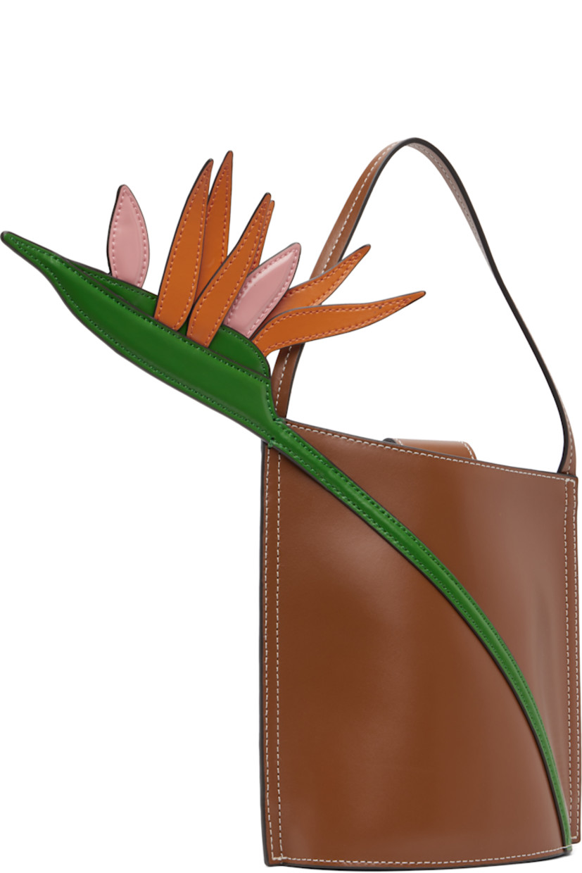 Polished leather top handle bag.

· Fixed carry handle
· Floral appliqué at face
· Logo embossed at back face
· Magnetic press-stud tab closure
· Suede interior
· Contrast stitching in white
· H7.5" x W6" x D3.75"

Supplier color: Tan