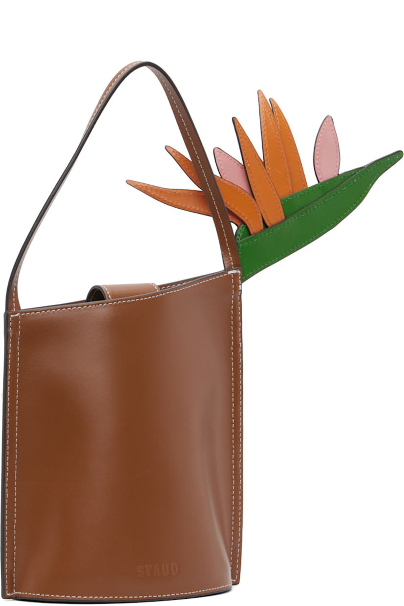 Polished leather top handle bag.

· Fixed carry handle
· Floral appliqué at face
· Logo embossed at back face
· Magnetic press-stud tab closure
· Suede interior
· Contrast stitching in white
· H7.5" x W6" x D3.75"

Supplier color: Tan