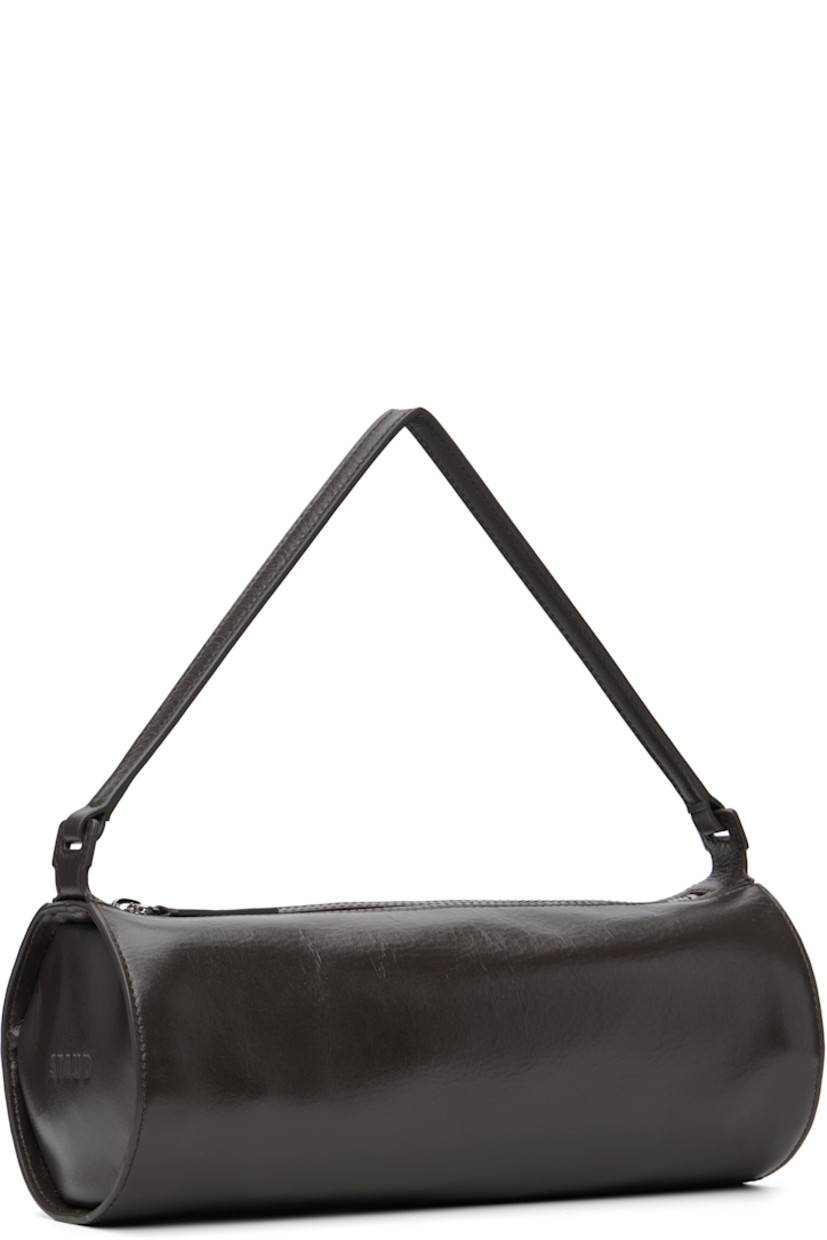 Grained leather shoulder bag.

· Fixed shoulder strap
· Logo embossed at side
· Zip closure
· Zip pocket at interior
· Faille lining
· H4.5" x W11.25" x D4.5"

Supplier color: Espresso