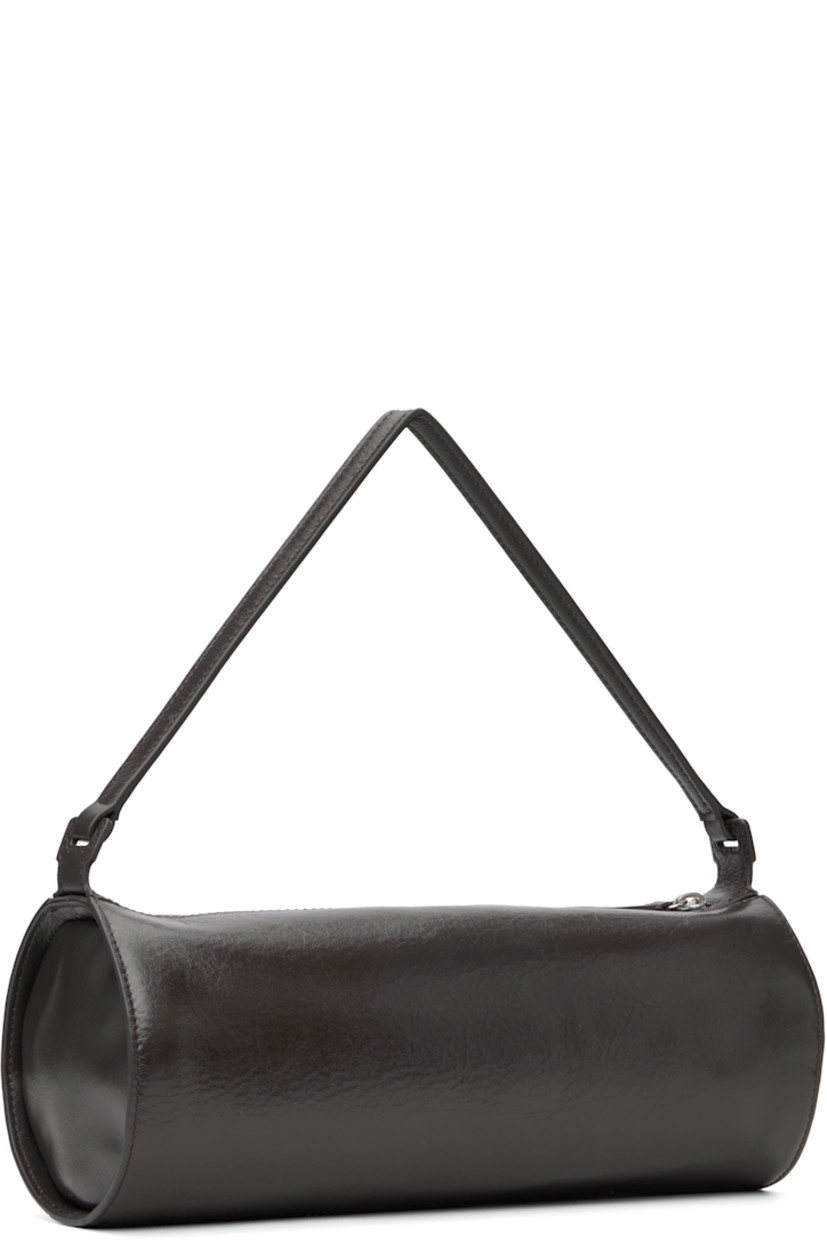 Grained leather shoulder bag.

· Fixed shoulder strap
· Logo embossed at side
· Zip closure
· Zip pocket at interior
· Faille lining
· H4.5" x W11.25" x D4.5"

Supplier color: Espresso