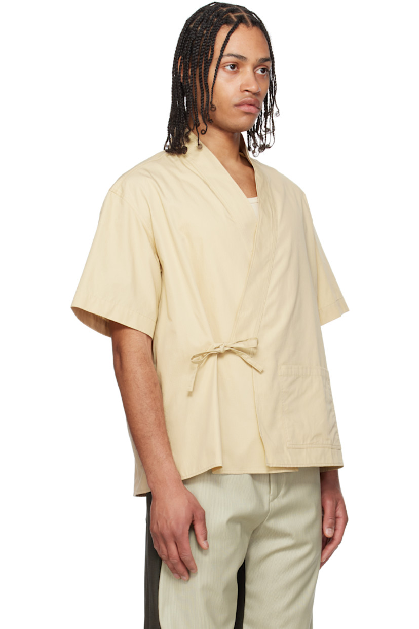 Cotton ripstop shirt.

· Wrap construction
· V-neck
· Patch pocket at front
· Self-tie fastening and concealed button tab at waist
· Vented side seams
· Dropped shoulders
· Logo patch at back collar

Supplier color: Beige