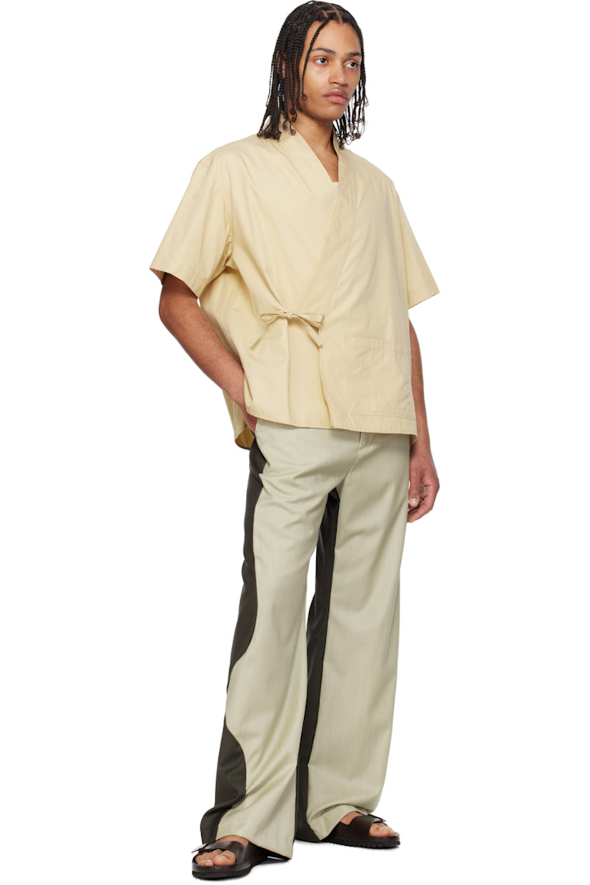 Cotton ripstop shirt.

· Wrap construction
· V-neck
· Patch pocket at front
· Self-tie fastening and concealed button tab at waist
· Vented side seams
· Dropped shoulders
· Logo patch at back collar

Supplier color: Beige