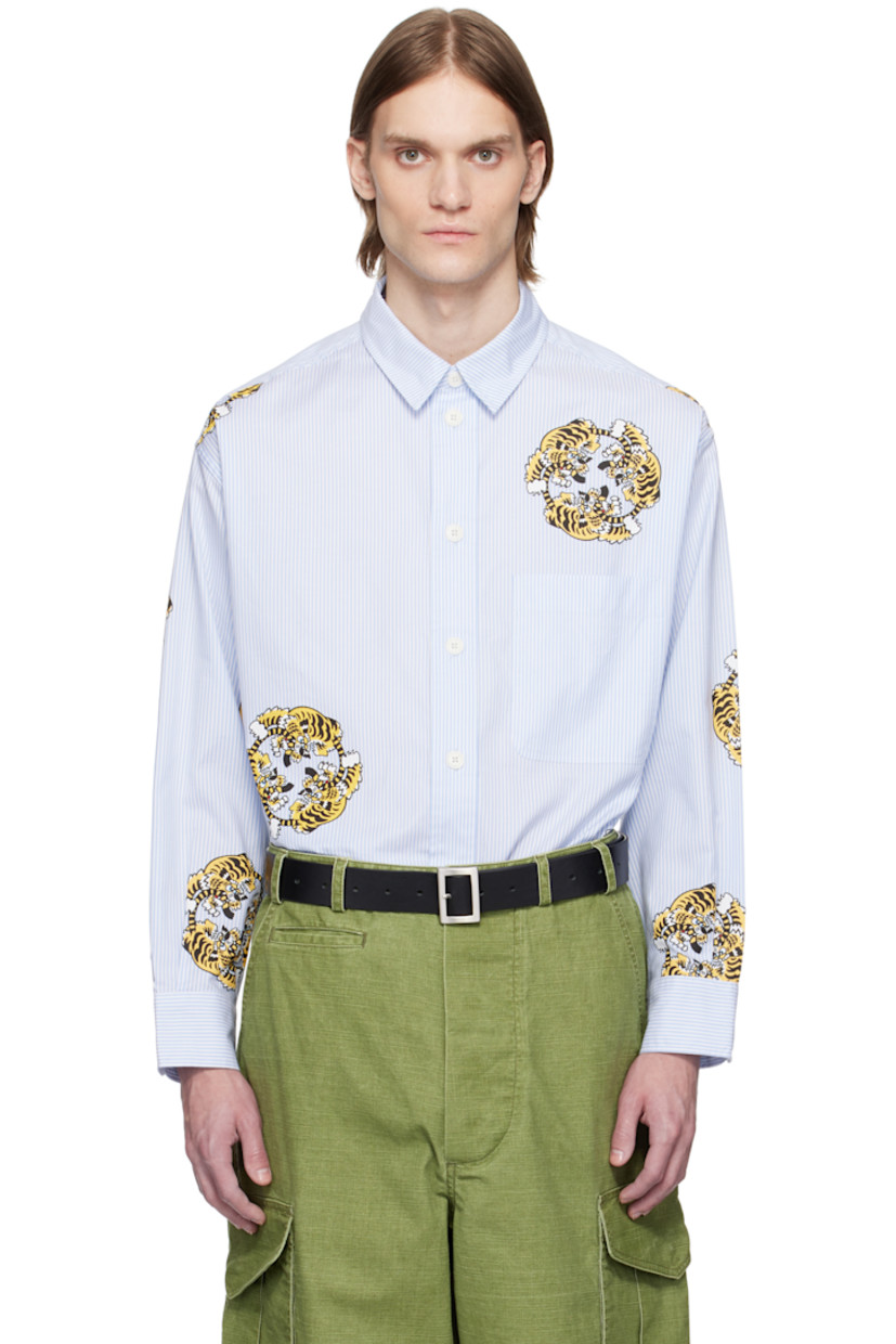 Oversized cotton poplin shirt. Jacquard stripes and printed graphics throughout.

· Spread collar
· Button closure
· Patch pocket at chest
· Vented side seams
· Dropped shoulders
· Pleats at buttoned barrel cuffs
· Logo-engraved hardware

Each item is unique. Please note finishing may vary.

Part of the KENZO VERDY Market collaboration.

Supplier color: Sky blue