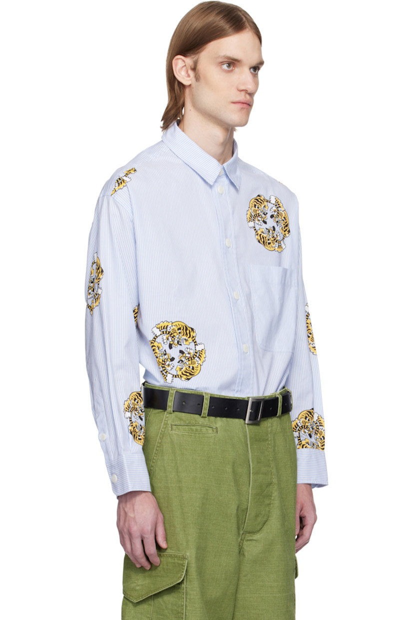 Oversized cotton poplin shirt. Jacquard stripes and printed graphics throughout.

· Spread collar
· Button closure
· Patch pocket at chest
· Vented side seams
· Dropped shoulders
· Pleats at buttoned barrel cuffs
· Logo-engraved hardware

Each item is unique. Please note finishing may vary.

Part of the KENZO VERDY Market collaboration.

Supplier color: Sky blue