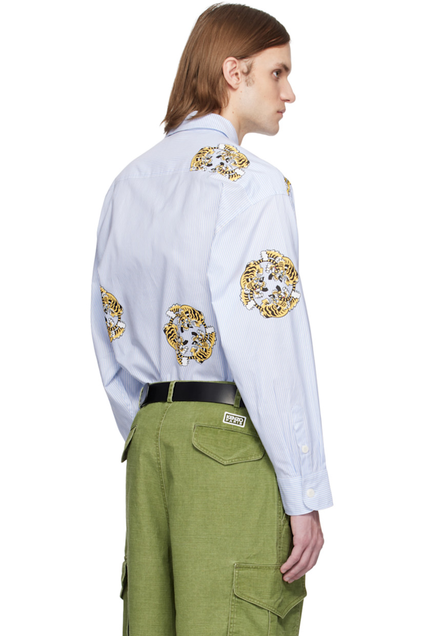 Oversized cotton poplin shirt. Jacquard stripes and printed graphics throughout.

· Spread collar
· Button closure
· Patch pocket at chest
· Vented side seams
· Dropped shoulders
· Pleats at buttoned barrel cuffs
· Logo-engraved hardware

Each item is unique. Please note finishing may vary.

Part of the KENZO VERDY Market collaboration.

Supplier color: Sky blue