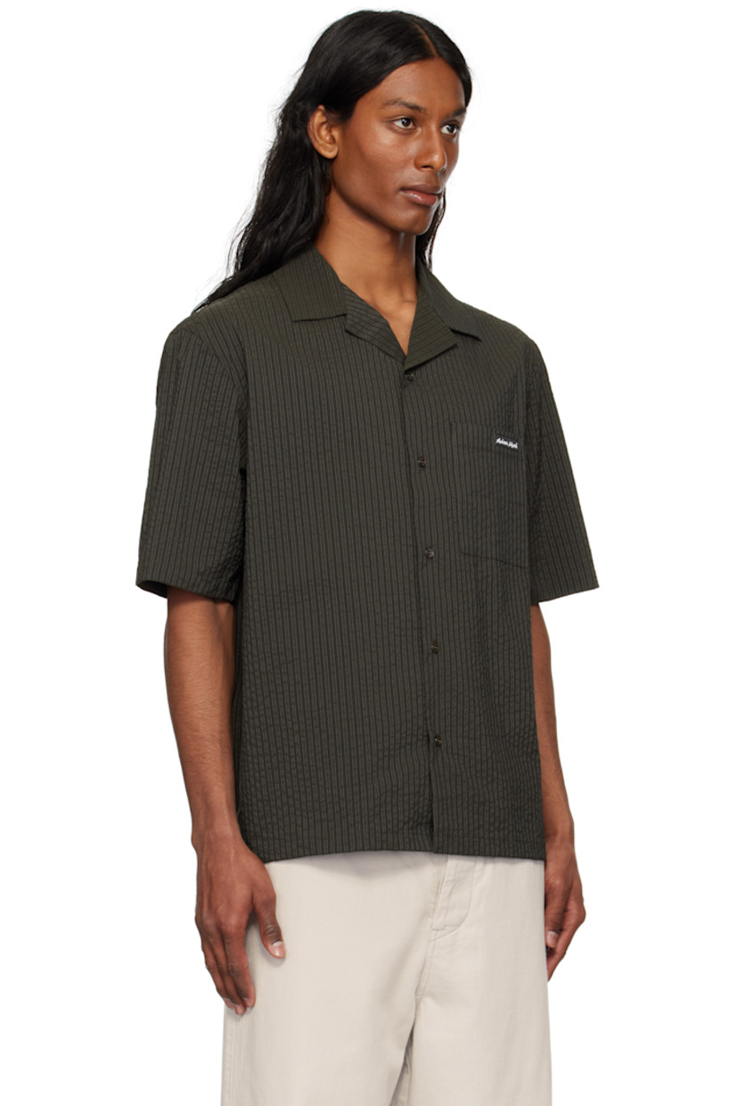 Boxy-fit polyester- and cotton-blend seersucker shirt. Stripes throughout.

· Open spread collar
· Button closure
· Logo patch at patch pocket 

Supplier color: Ranger green