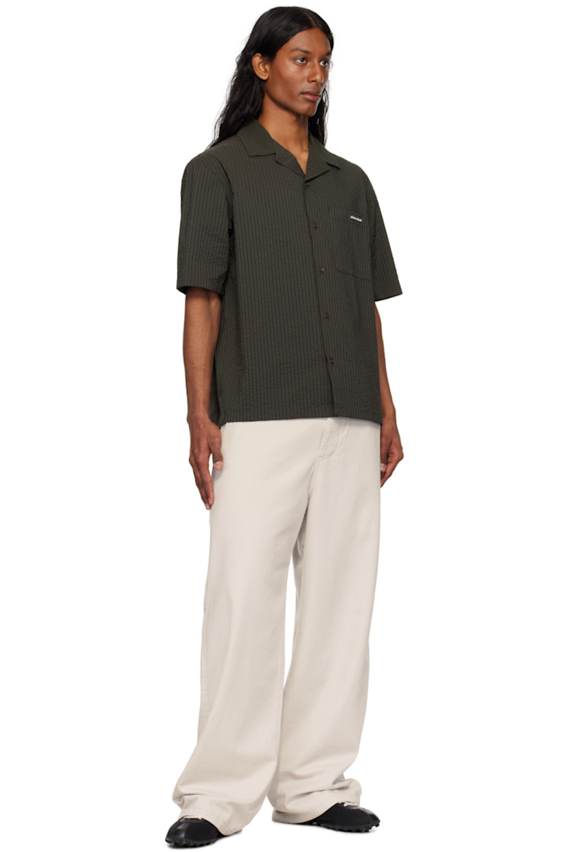 Boxy-fit polyester- and cotton-blend seersucker shirt. Stripes throughout.

· Open spread collar
· Button closure
· Logo patch at patch pocket 

Supplier color: Ranger green