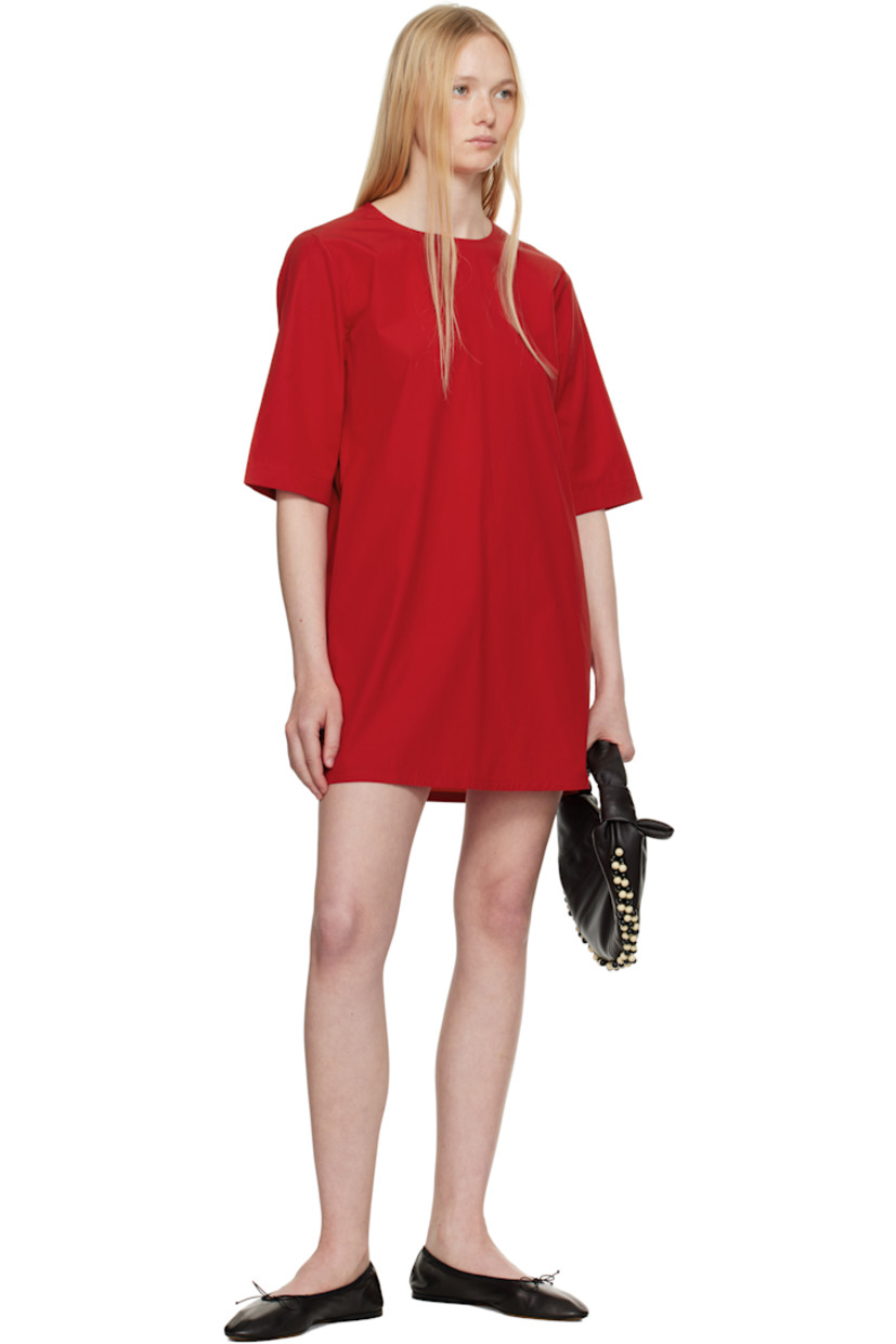 Organic cotton poplin minidress. 

· Round neck
· Seam pockets
· Dropped shoulders
· Self-tie keyhole with extended silk drawstring at back
· Twin pleats at back yoke
· Unlined

Supplier color: Red apple