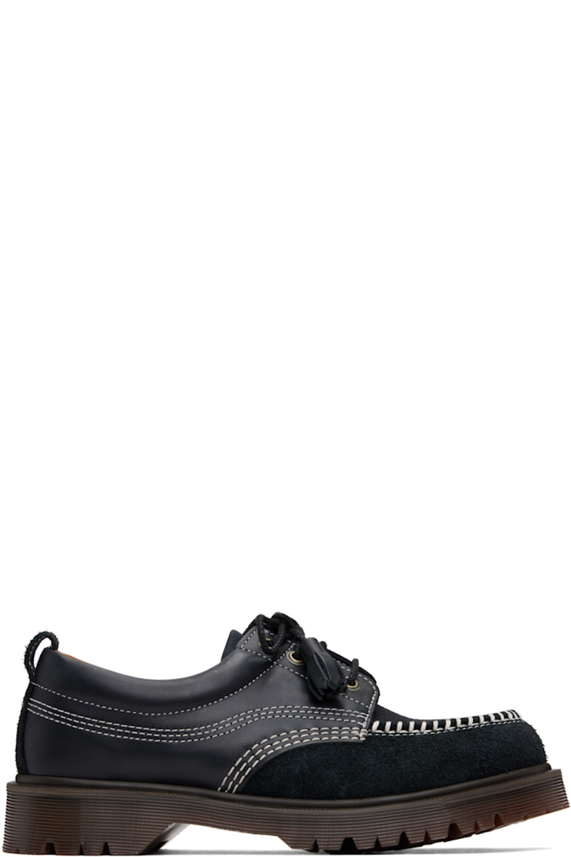 Buffed leather, nubuck, and suede derbys in black.

· Blanket stitching at moc toe
· Tassel detailing at lace-up closure
· Padded collar
· Pull-loop at heel collar
· Buffed leather lining
· Heat-sealed Goodyear welt
· Treaded Air Cushion rubber sole
· Contrast stitching in white

Supplier color: Black kinsley tumble