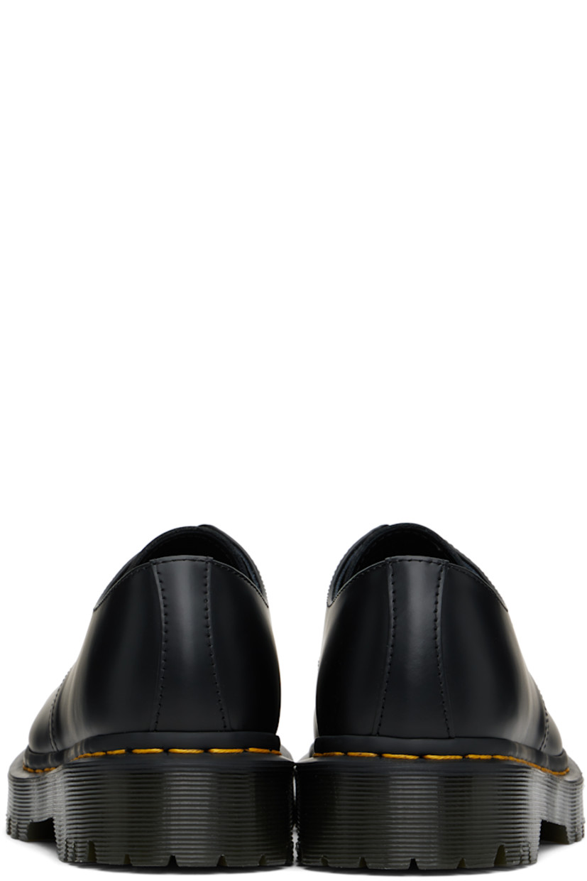 Polished leather derbys in black.

· Lace-up closure
· Buffed leather lining
· Yellow topstitching at heat-sealed Goodyear welt
· Treaded Air Cushion rubber sole

Supplier color: Black smooth