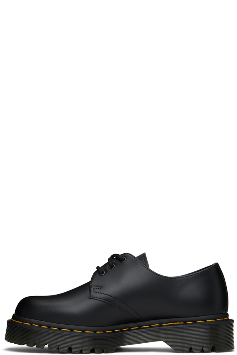 Polished leather derbys in black.

· Lace-up closure
· Buffed leather lining
· Yellow topstitching at heat-sealed Goodyear welt
· Treaded Air Cushion rubber sole

Supplier color: Black smooth