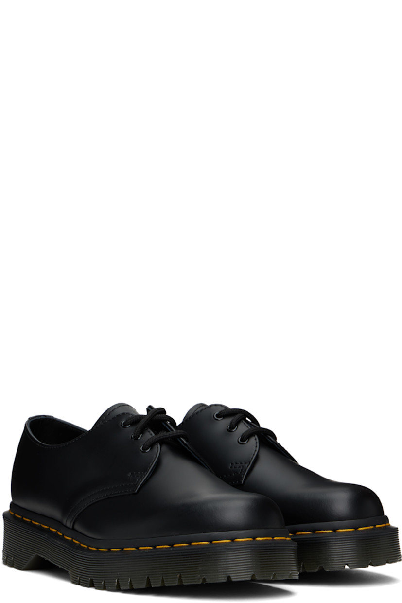Polished leather derbys in black.

· Lace-up closure
· Buffed leather lining
· Yellow topstitching at heat-sealed Goodyear welt
· Treaded Air Cushion rubber sole

Supplier color: Black smooth