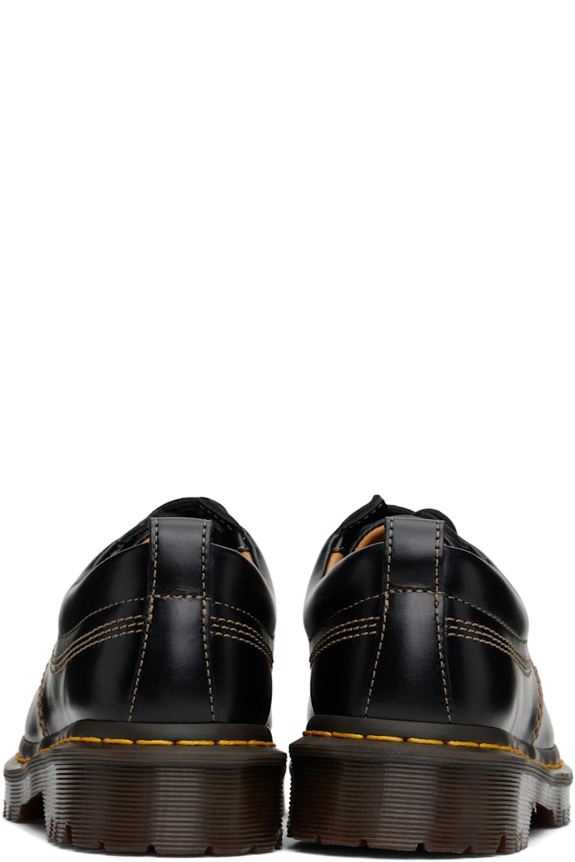 Buffed leather derbys in black.

· Blanket stitching at moc toe
· Lace-up closure
· Padded collar
· Pull-loop at heel collar
· Yellow topstitching at heat-sealed Goodyear welt
· Treaded Air Cushion rubber sole
· Contrast stitching in beige

Supplier color: Black analine