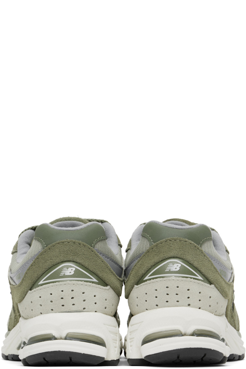 Low-top suede and mesh sneakers in khaki.

· Logo embroidered at vamp
· Lace-up closure
· Inset logo patch at padded tongue
· Padded collar
· Reflective logo appliqué at sides
· Perforated detailing at heel counter
· Jersey lining
· ABZORB® foam rubber midsole
· Treaded N-ergy rubber sole
· Stability Web technology at sole

Supplier color: Dark olivine/Olivine/Slate grey