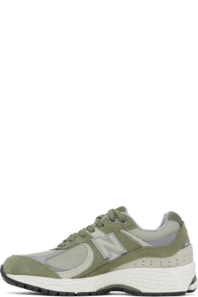 Low-top suede and mesh sneakers in khaki.

· Logo embroidered at vamp
· Lace-up closure
· Inset logo patch at padded tongue
· Padded collar
· Reflective logo appliqué at sides
· Perforated detailing at heel counter
· Jersey lining
· ABZORB® foam rubber midsole
· Treaded N-ergy rubber sole
· Stability Web technology at sole

Supplier color: Dark olivine/Olivine/Slate grey