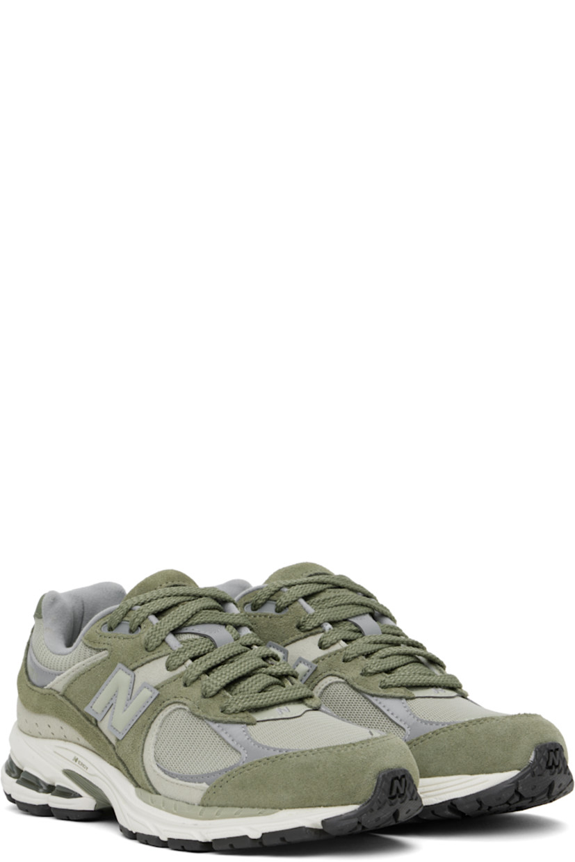 Low-top suede and mesh sneakers in khaki.

· Logo embroidered at vamp
· Lace-up closure
· Inset logo patch at padded tongue
· Padded collar
· Reflective logo appliqué at sides
· Perforated detailing at heel counter
· Jersey lining
· ABZORB® foam rubber midsole
· Treaded N-ergy rubber sole
· Stability Web technology at sole

Supplier color: Dark olivine/Olivine/Slate grey