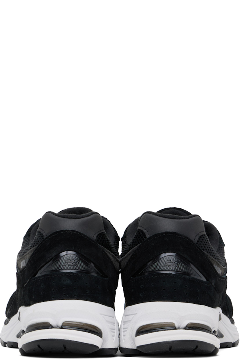 Low-top suede and mesh sneakers in black.

· Logo embroidered at vamp
· Lace-up closure
· Inset logo patch at padded tongue
· Padded collar
· Reflective logo appliqué at sides
· Perforated detailing at heel counter
· Jersey lining
· ABZORB® foam rubber midsole
· Treaded N-ergy rubber sole
· Stability Web technology at sole

Supplier color: Black/Phantom/Gunmetal