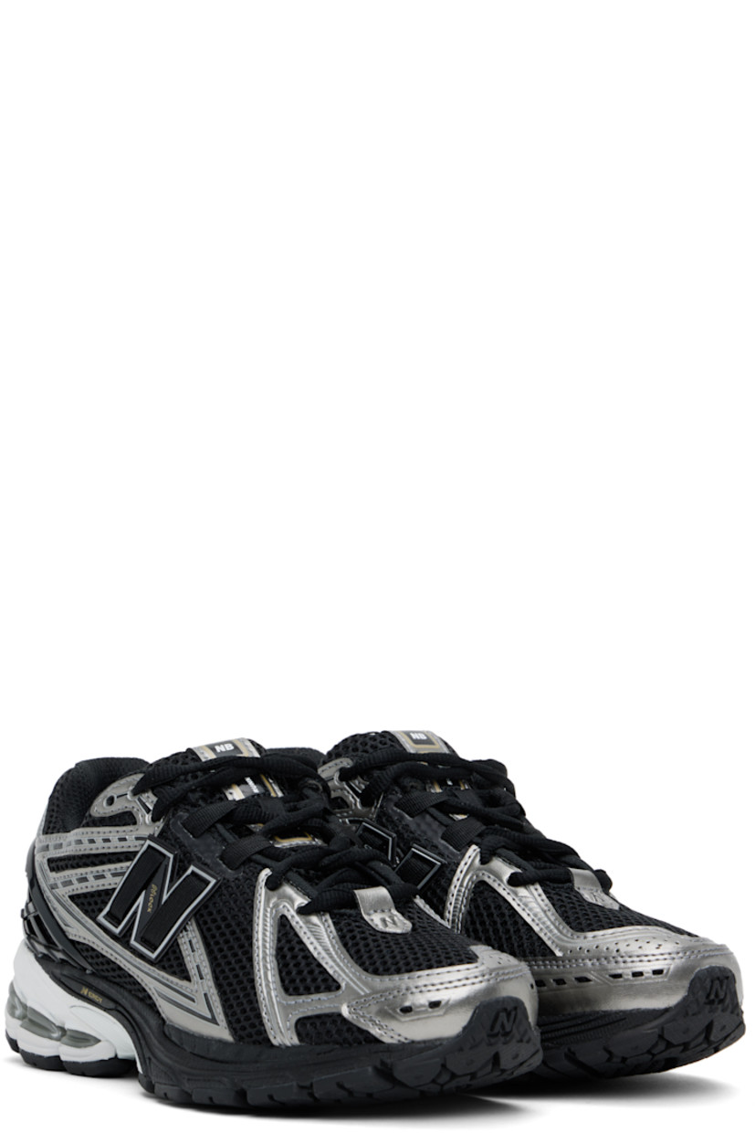 Low-top mesh sneakers in black and silver tone.

· Grained faux-leather trim throughout
· Logo embossed at toe and lace-up closure
· Logo patch at padded tongue
· Padded collar
· Logo appliqué at sides
· Logo-embossed rubberized trim at heel counter
· Mesh lining
· ABZORB SBS foam rubber midsole
· ACTEVA LITE unit at foam midsole
· Treaded N-ergy and Stability Web rubber sole

Supplier color: Black